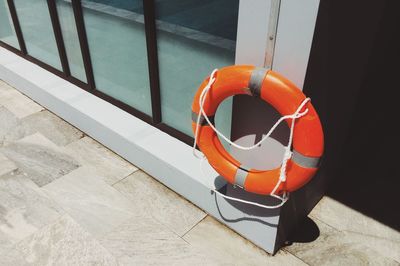 High angle view of life belt hanging on wall