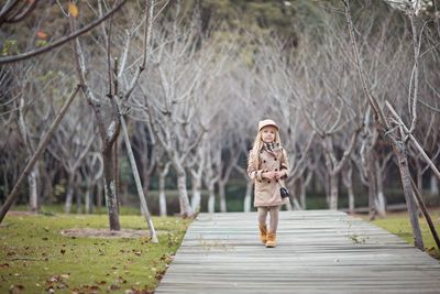 Girl walking on footpath at park