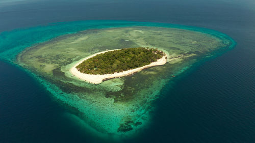 Small tropical island on an atoll with beautiful sandy beach. camiguin, philippines, mindanao