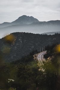 High angle view of road by mountains against sky