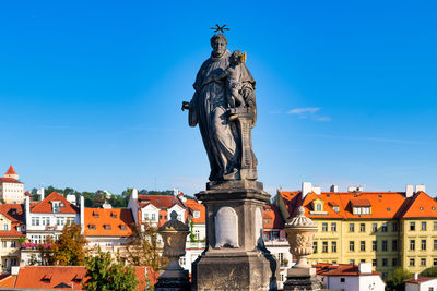 Statue of a building with city in background