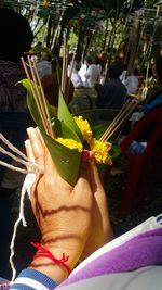 Close-up of hand holding flower bouquet