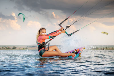 Woman kitesurfing at sea