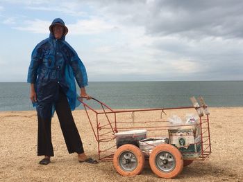 Man standing by sea against sky