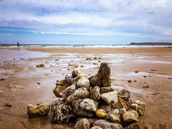 Rocks on beach against sky