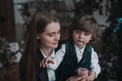 Portrait of mother and girl looking at camera