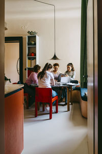 Female friends doing homework together while studying at home