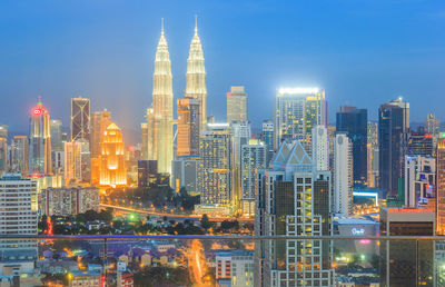 Illuminated cityscape against sky at night