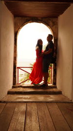 Man and woman standing on step by railing