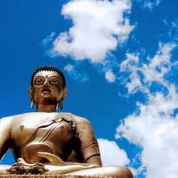 Low angle view of statue against blue sky