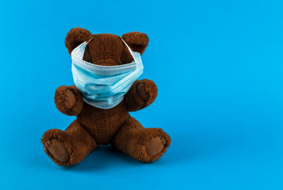 Close-up of stuffed toy against blue background