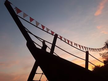 Low angle view of silhouette bridge against sky during sunset