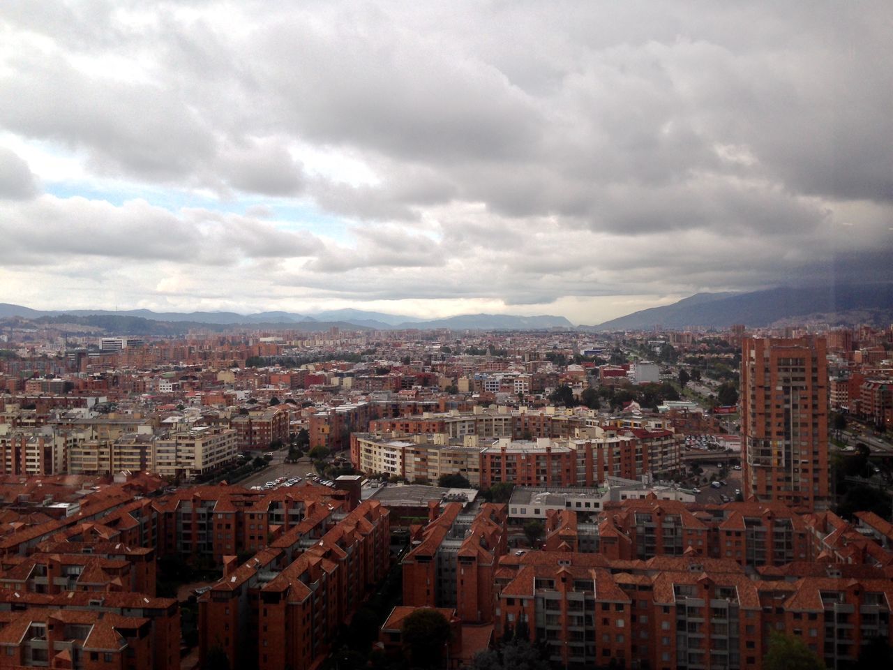 building exterior, architecture, cityscape, built structure, city, sky, cloud - sky, crowded, residential district, cloudy, high angle view, cloud, mountain, residential building, residential structure, mountain range, outdoors, city life, no people, community