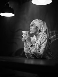 Portrait of young woman using mobile phone