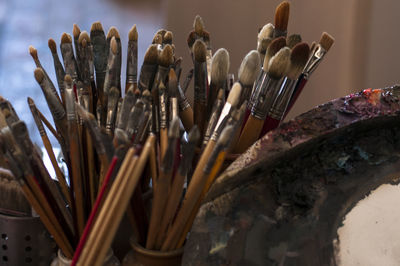 Close-up of paintbrushes in containers