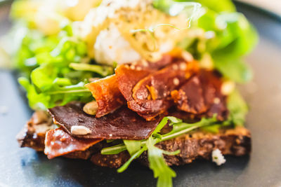 Selective focus of sandwich with dried jamon and arugula. weekend breakfast in the restaurant.