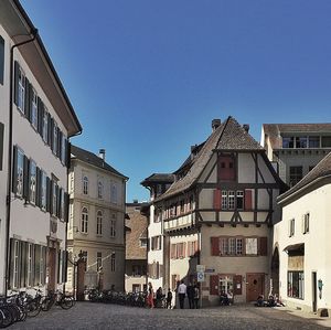 Buildings in city against blue sky