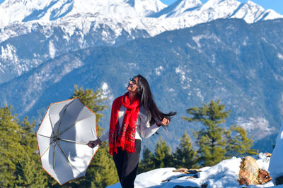 Woman standing on snow covered mountain