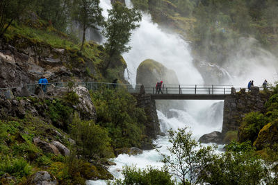 Scenic view of waterfall against mountain