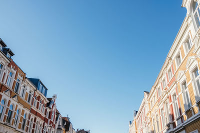 Low angle view of residential building against clear blue sky