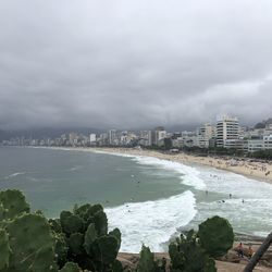 Scenic view of sea by buildings against sky