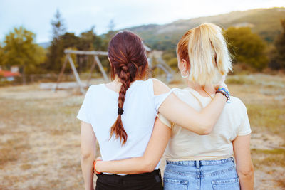 Rear view of women standing on land