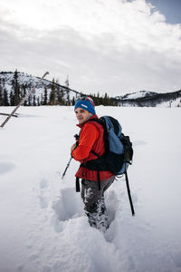 Person sitting on snow covered field