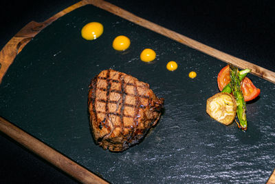 A chargrilled argentinian fillet steak served on a flint chopping board