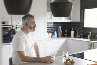 Man sitting on table at home