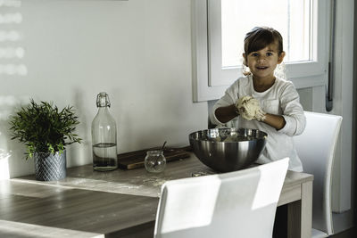 Portrait of girl preparing food at home