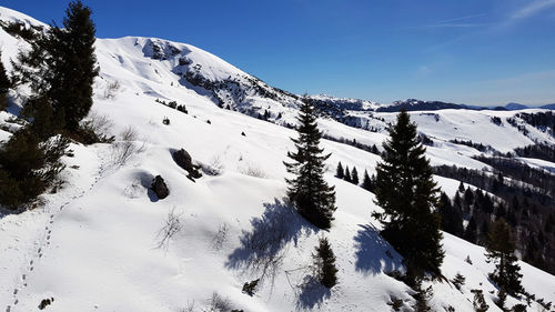 Scenic view of snow covered mountains against sky