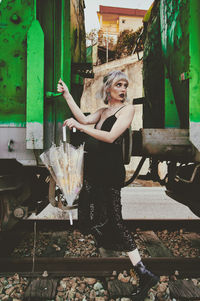 Woman looking away while walking in shunting yard