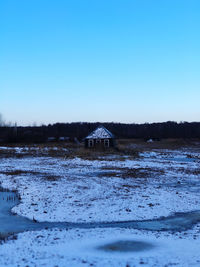 Scenic view of snowcapped landscape against clear blue sky