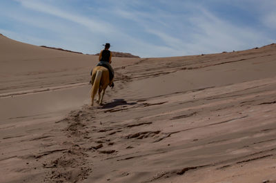  walking on sand dune in desert
