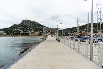 View of pier on beach against sky