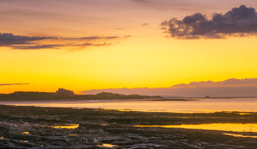 Scenic view of dramatic sky during sunset over seahouses norrhumberland