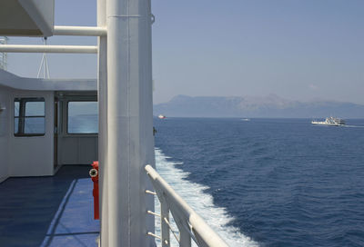 Boat sailing on sea against clear sky