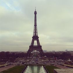 Silhouette of eiffel tower against cloudy sky