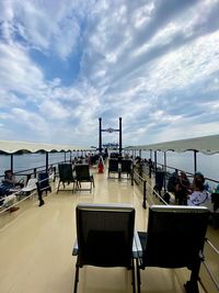 People on table by sea against sky