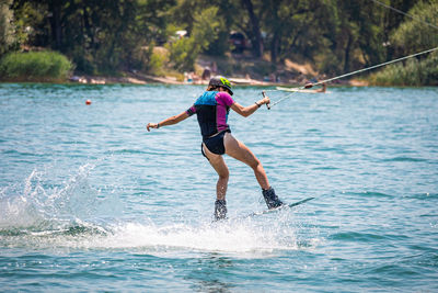 Rear view of man jumping in sea