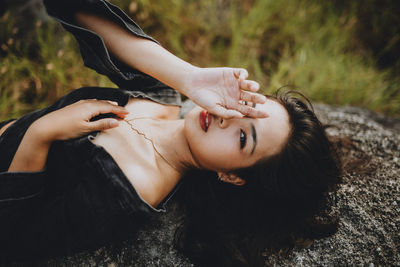 Portrait of woman lying down on land