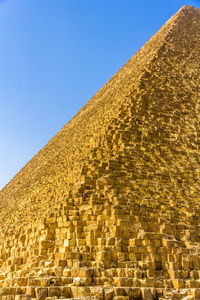 Low angle view of historical building against blue sky