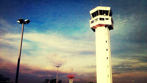 Low angle view of lighthouse against cloudy sky