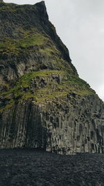 Scenic view of rock formation by sea against sky