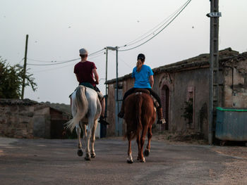 Rear view of men riding