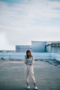 Full length of woman standing against sky
