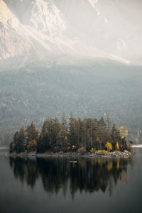 Scenic view of lake by trees against mountain