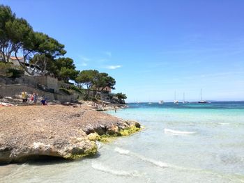 Scenic view of beach against blue sky