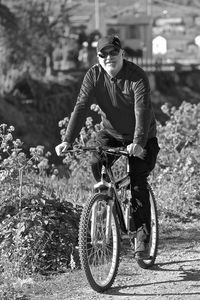 Portrait of young man riding bicycle