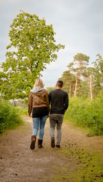 Rear view of two women walking in park